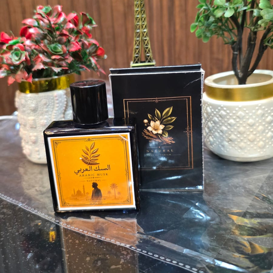 Fragrance bottle with decorative items on a reflective surface