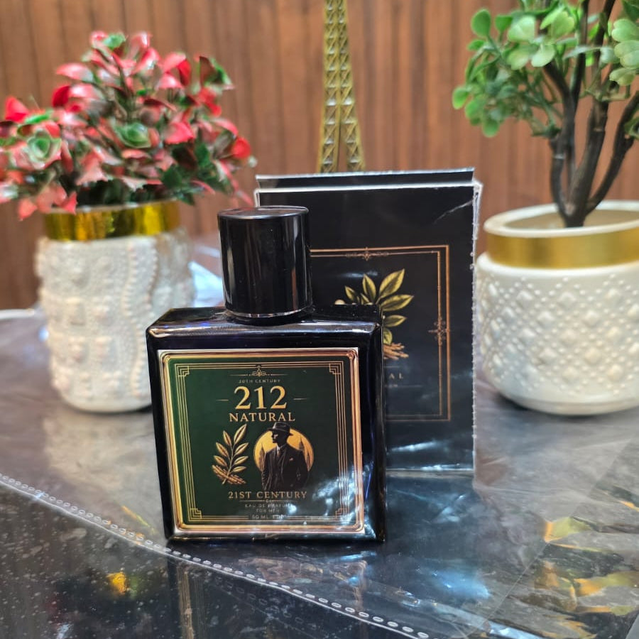Perfume bottle labeled '212' on a reflective surface with decorative plants and a small tower model in the background.